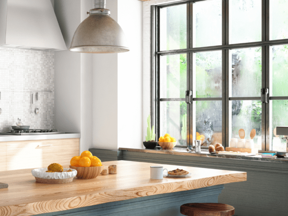 Modern kitchen with white cabinets, island, and stainless steel appliances in Kitchener Waterloo home