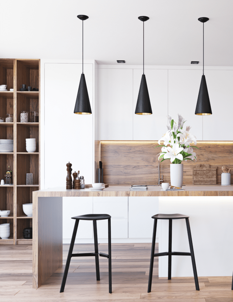 Modern kitchen with white cabinets, island, and stainless steel appliances in Kitchener Waterloo home